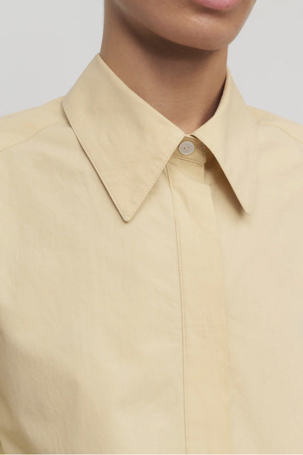 Front closeup view of sand margan shirt on model, against a white background.