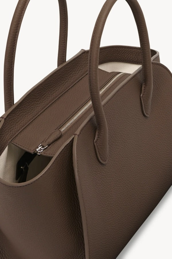 Zipper view of dark olive marlo 12 bag on white background, with no model shown.