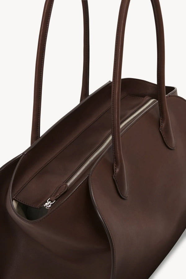 Zipper view of deep brown marlo 14 bag on white background, with no model shown.