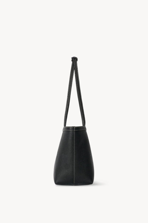 Side view of black medium park tote on white background, with no model shown.