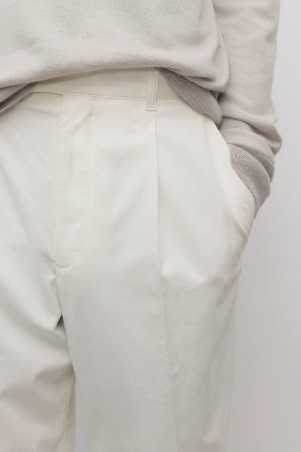 Front closeup view of white belamy pant on model wearing beige top, against a white background.