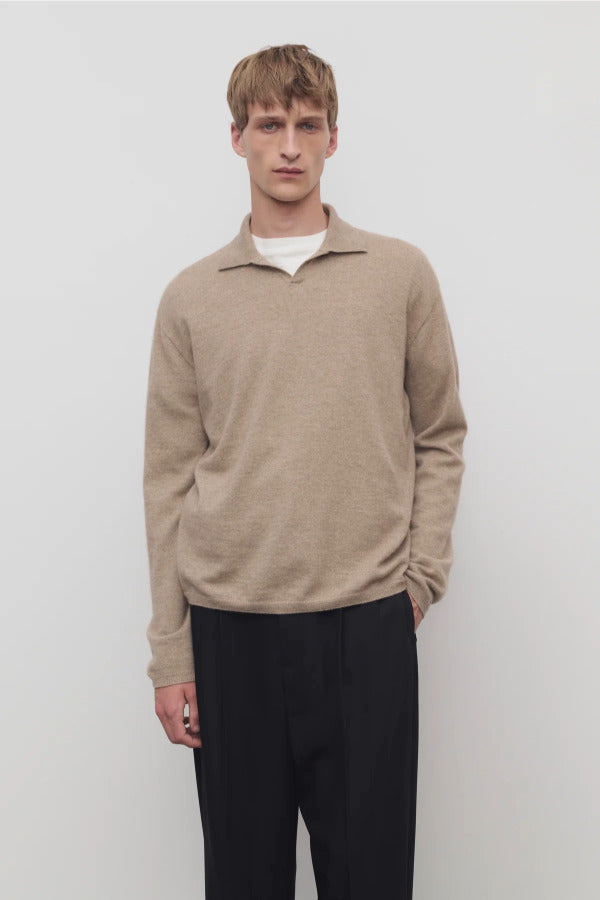 Front view of taupe men's franz sweater on model wearing black trousers, against a white background.