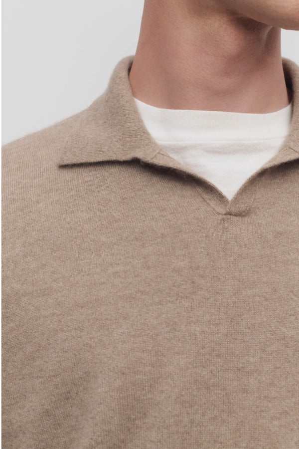 Front closeup view of taupe men's franz sweater on model wearing white undershirt, against a white background.