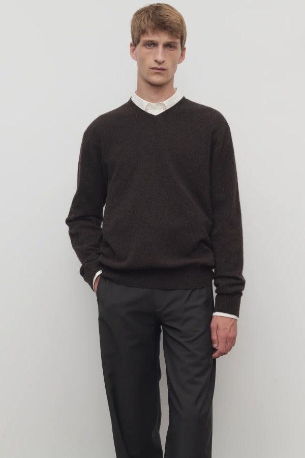 Front view of brown melange rod sweater on model wearing white shirt and grey trousers, against a white background.
