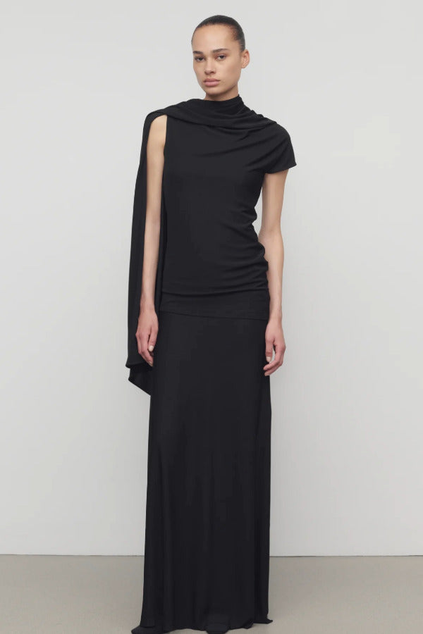 Front view of black mirla skirt on model wearing black top, against a white background.