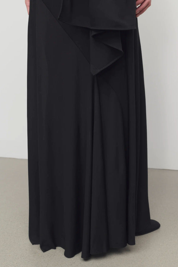 Back closeup view of black mirla skirt on model, against a white background.