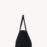 Side view of black park tote three canvas on white background, with no model showm.