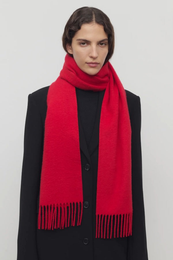 Front view of goji berry perico scarf on model wearing black suit, against a white background.