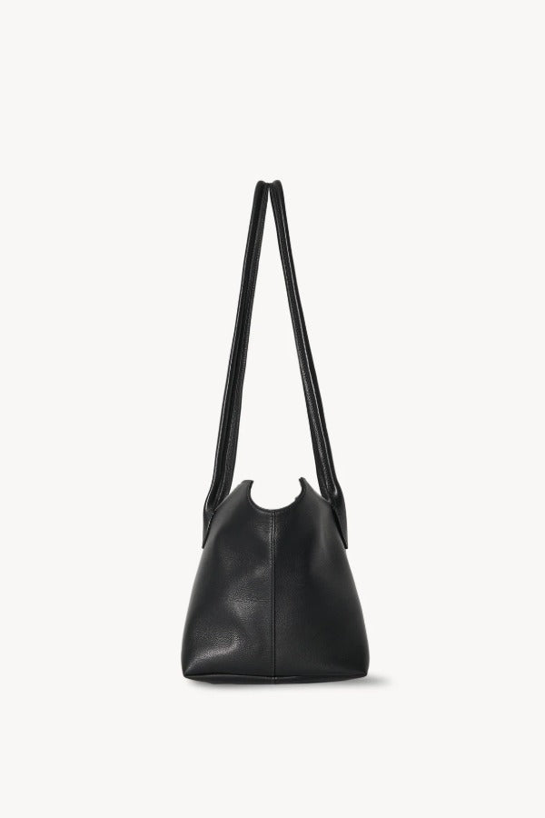 Side view of black terrasse bag on white background, with no model shown.