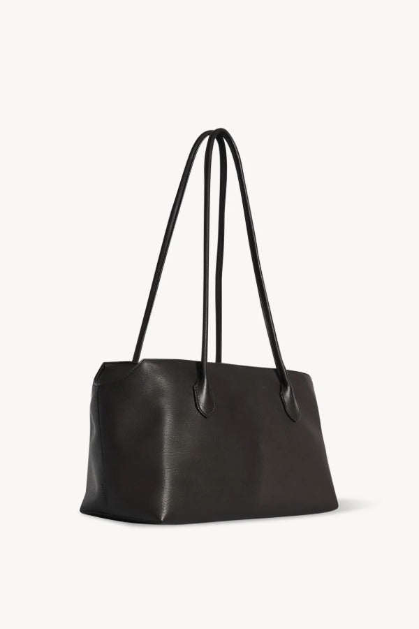 Front slanted view of dark brown terrasse bag on white background, with no model shown.