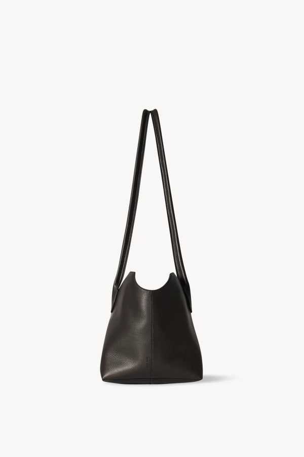 Side view of dark brown terrasse bag on white background, with no model shown.