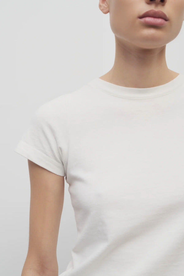 Front closeup view of white tori top on model against a white background.