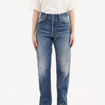 Front view of damaged social sculpture w18 jean on model wearing white t-shirt and sneakers, against a white background.