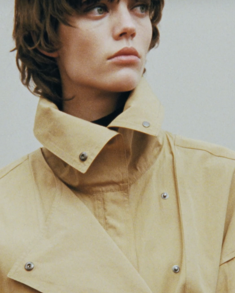 A woman with short hair wearing a coat from The Row. 