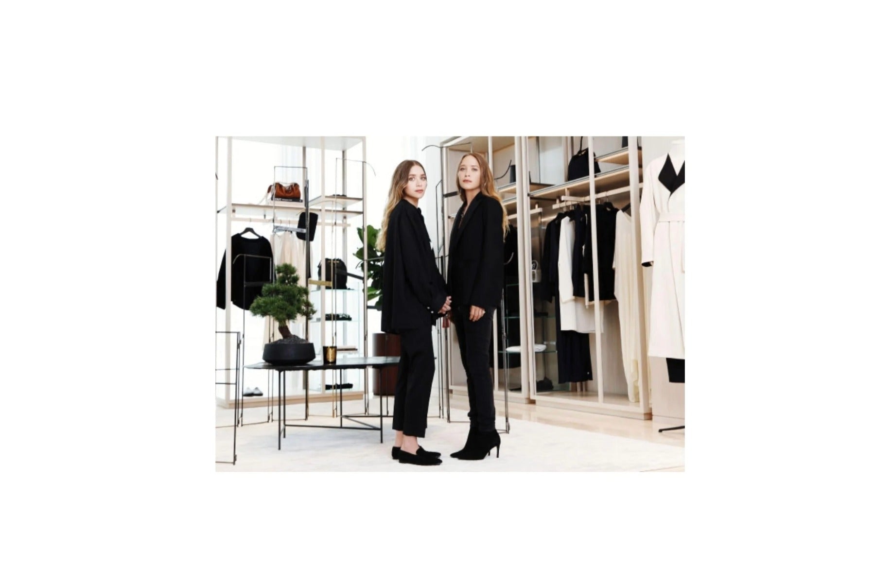 A woman with short hair wearing a coat from The Row. 