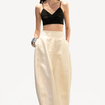 Front view of ivory callum persimmon skirt on model wearing black bralette, against a white background.