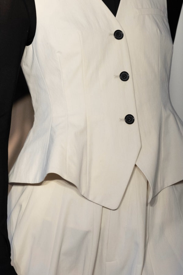 Front closeup of ivory william vest on model wearing ivory trousers, against a white background.