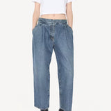 Front view of blanc cropped t-shirt on model wearing jeans and heels, against a white background.