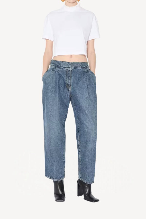 Front view of blanc cropped t-shirt on model wearing jeans and heels, against a white background.