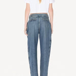Back view of blanc cropped t-shirt on model wearing jeans and heels, against a white background.