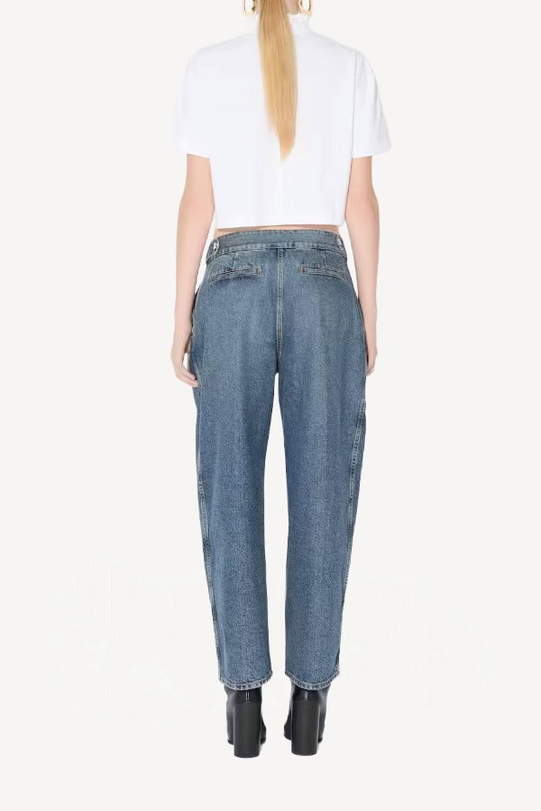Back view of blanc cropped t-shirt on model wearing jeans and heels, against a white background.