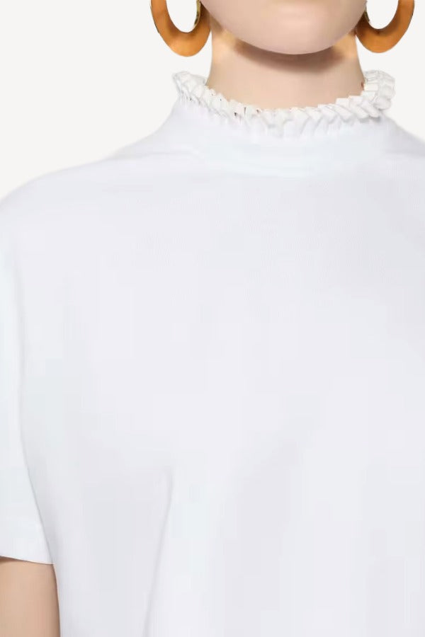 Front closeup view of blanc cropped t-shirt on model, against a white background.