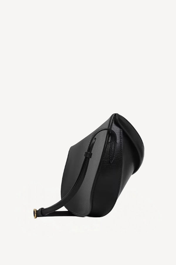 Side view of noir hip east west bag on white background, with no model shown.