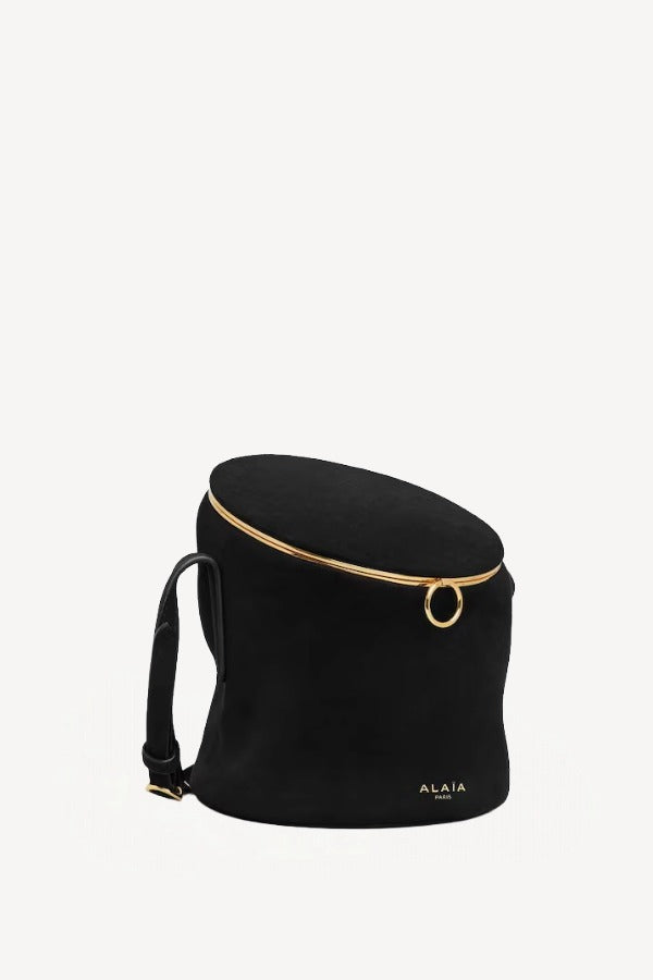 Side slanted view of noir la canette small bag on white background, with no model shown.