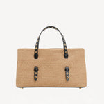 Front view of natural bag in straw on white background, with no model shown.