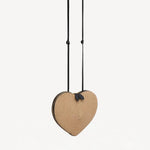 Front slanted view of natural heart bag in straw on white background, with no model shown