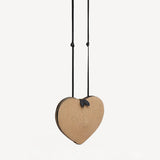 Front slanted view of natural heart bag in straw on white background, with no model shown