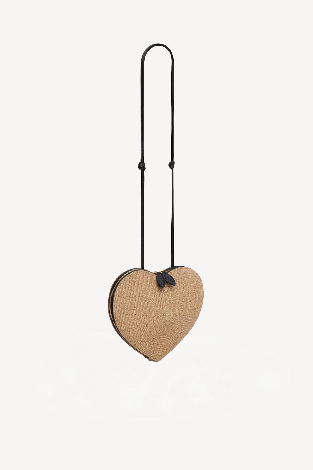 Front slanted view of natural heart bag in straw on white background, with no model shown