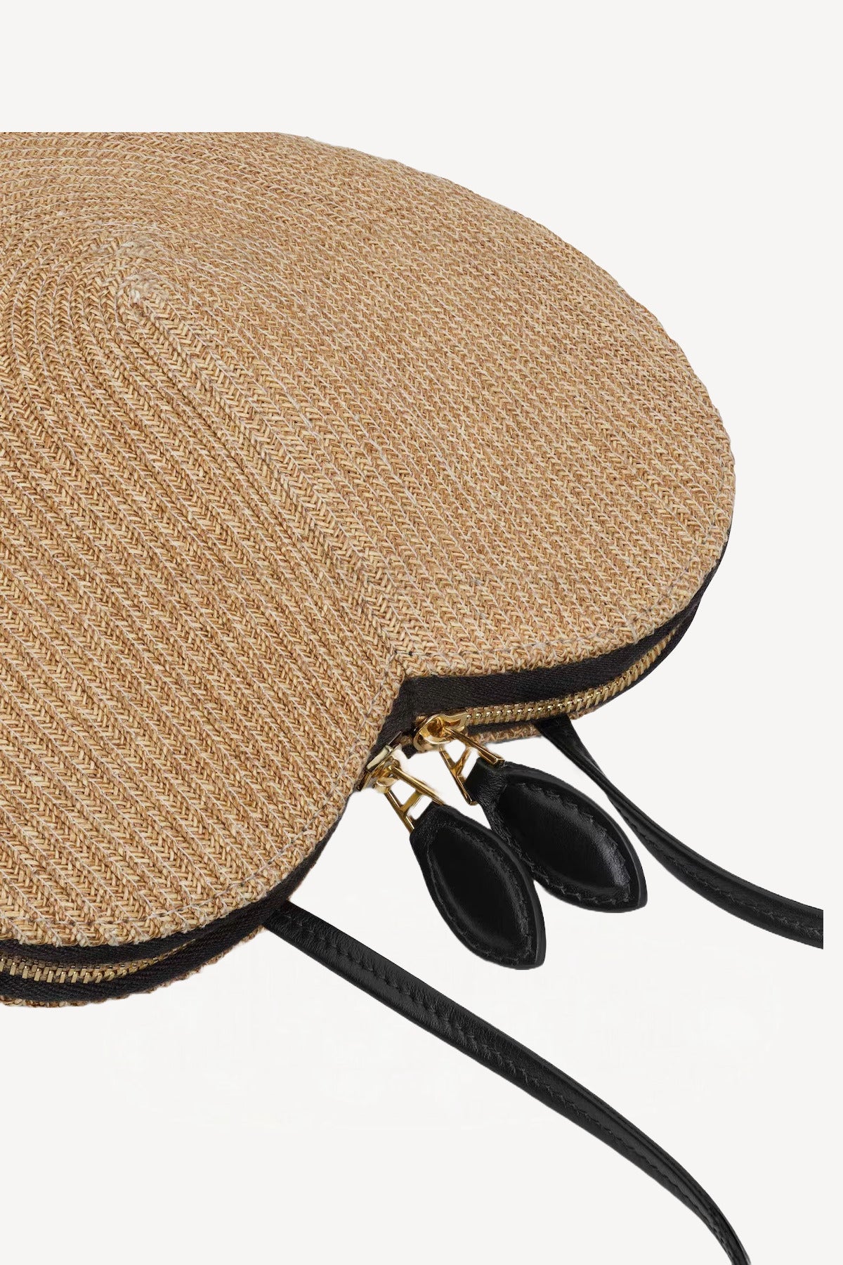 Side closeup view of the natural heart bag in straw on white background, with no model shown.