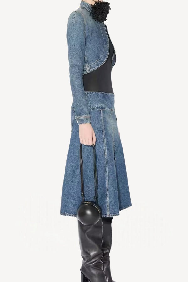 Side view of denim slit skirt on model wearing denim jacket, black bodysuit and boots, against a white background.
