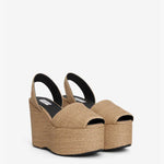 Front slanted view of natural wedge slingback in paper straw, against a white background with no model shown.