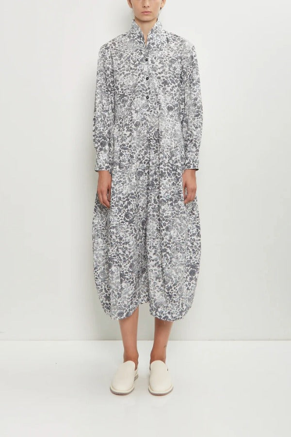 Front view of bright flower letty dress on model wearing white flowers, against a white background