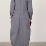Back view of fog letty dress on model wearing black oxfords, against a white background.