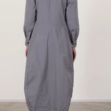 Back view of fog letty dress on model wearing black oxfords, against a white background.