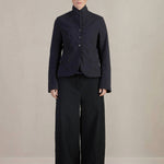 Front view of pinstripe caryl jacket on model wearing black trousers against a white background