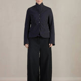 Front view of pinstripe caryl jacket on model wearing black trousers against a white background