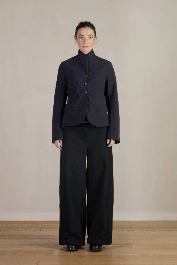 Front view of pinstripe caryl jacket on model wearing black trousers against a white background