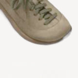 Left side overview of taupr uerzell sneaker on white background, with no model