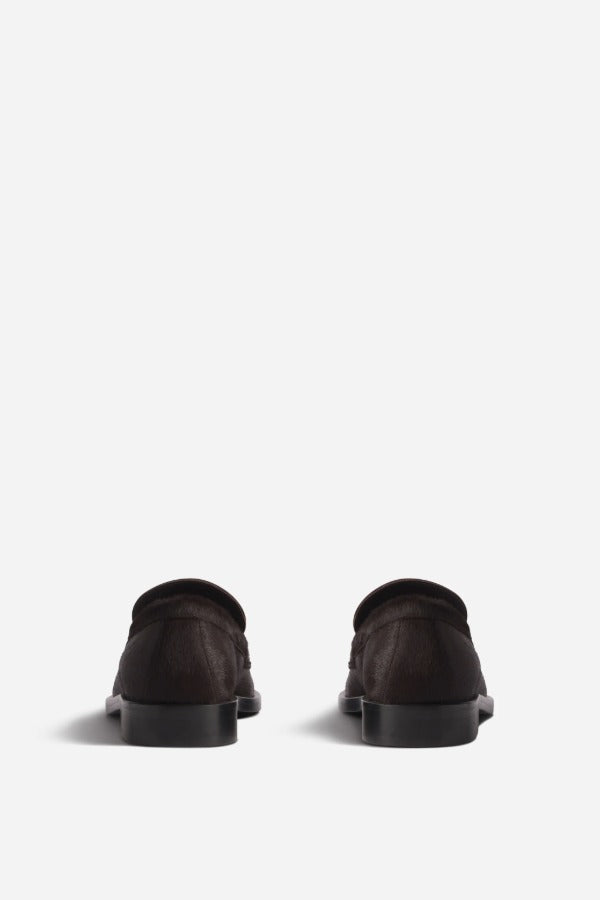 Back view of chocolate calf hair loafer on white background, with no model shown.