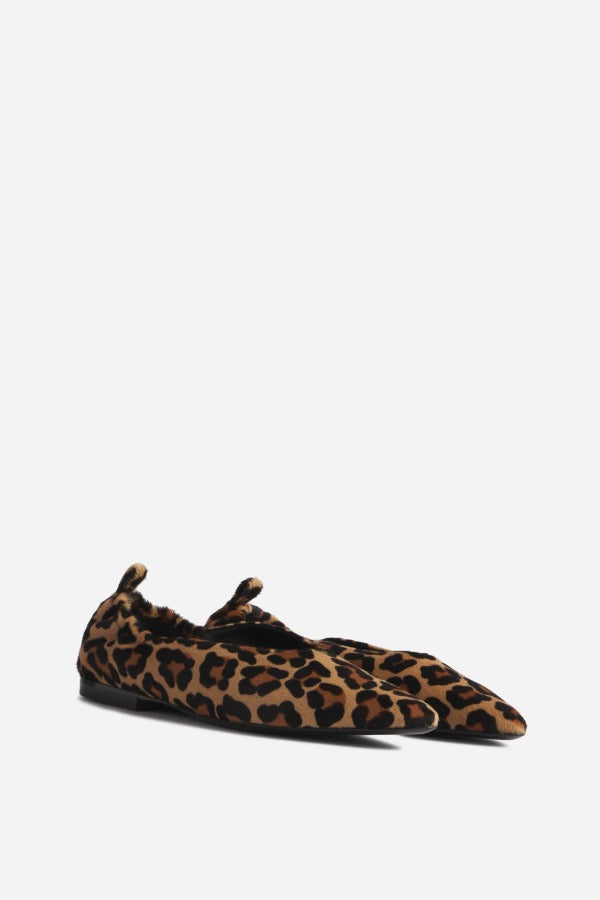 Front slanted view of leopard pointed elasticized slipper on white background, with no model shown.