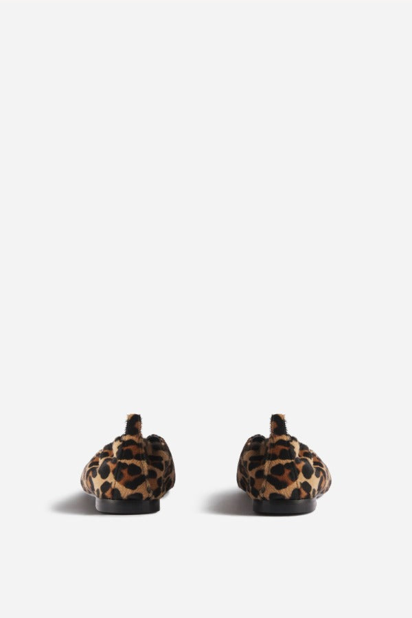 Back view of leopard pointed elasticized slipper on white background, with no model shown.