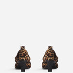 Back view of leopard calf hair pointed ruched pumps on white background, with no model shown.