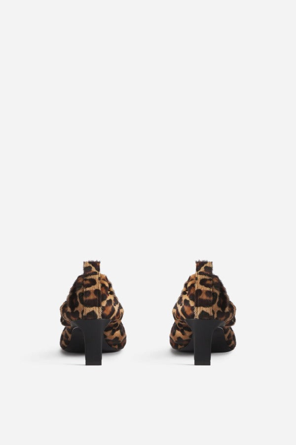 Back view of leopard calf hair pointed ruched pumps on white background, with no model shown.