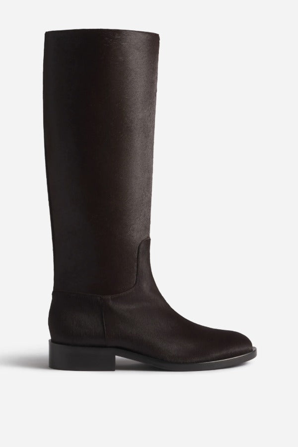 Right side view of chocolate calf hair riding boot on white background, with no  model shown.