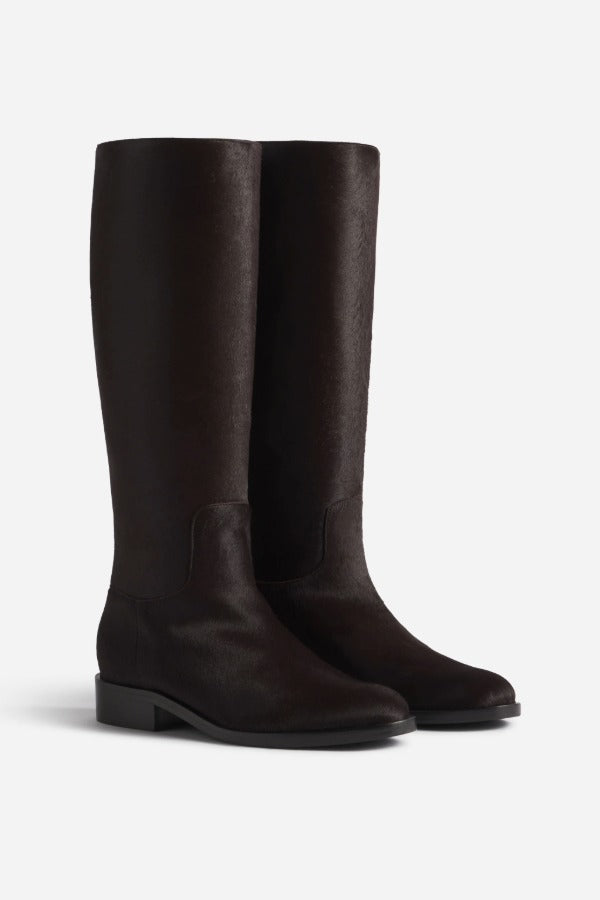 Pair view of chocolate calf hair riding boot, on white background, with no model shown.