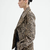 Side view of leopard peacoat on model wearing black top and pants, against a white background.